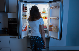 person looking in fridge